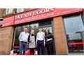 Mum, dad, son and daughter working together for Dream Doors